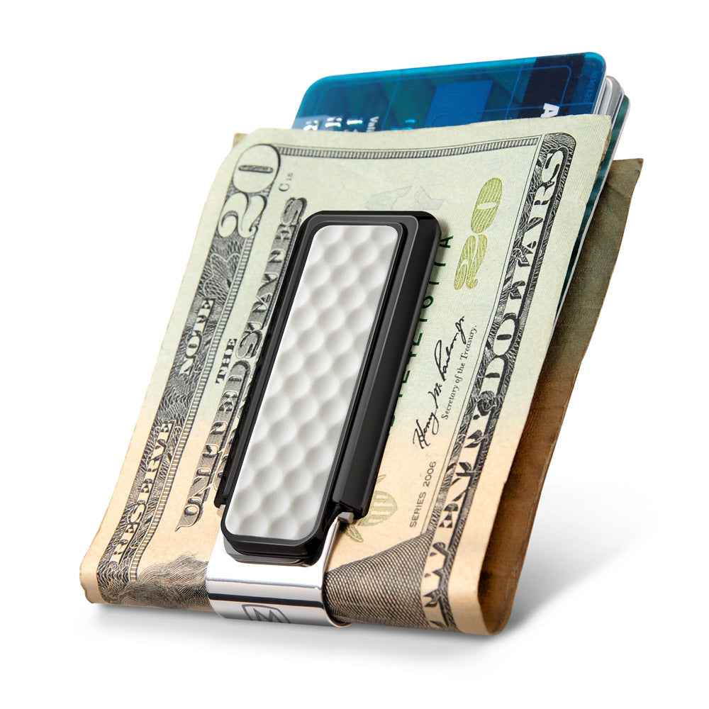 Black golf ball money clip in pocket lifestyle shot